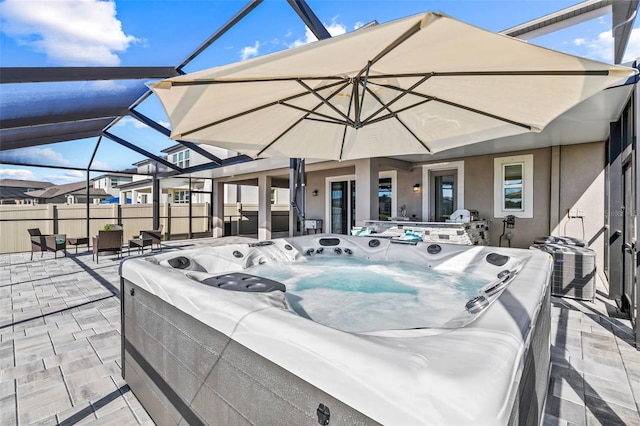 3071 Marine Grass Dr, Wimauma, FL 33598 - view of patio featuring a hot tub, a lanai, fence, and central AC
