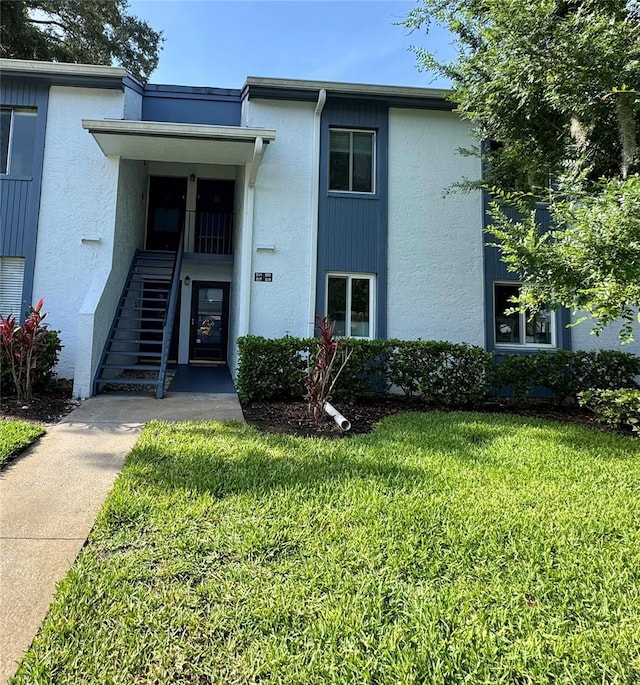 220 Cypress Ln Unit 220, Oldsmar, FL 34677 - view of front of home with a front yard and stucco siding