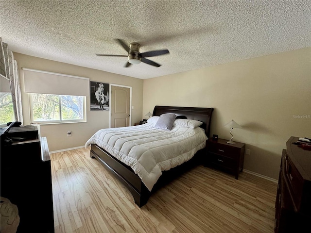 220 Cypress Ln Unit 220, Oldsmar, FL 34677 - bedroom featuring wood finished floors, baseboards, ceiling fan, and a textured ceiling