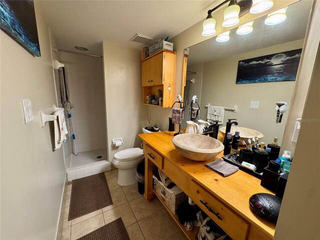 220 Cypress Ln Unit 220, Oldsmar, FL 34677 - full bath featuring tile patterned flooring, a tile shower, toilet, a workshop area, and vanity