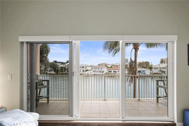 205 Brightwater Dr Unit 101, Clearwater Beach, FL 33767 - entryway featuring a water view, a residential view, and tile patterned flooring