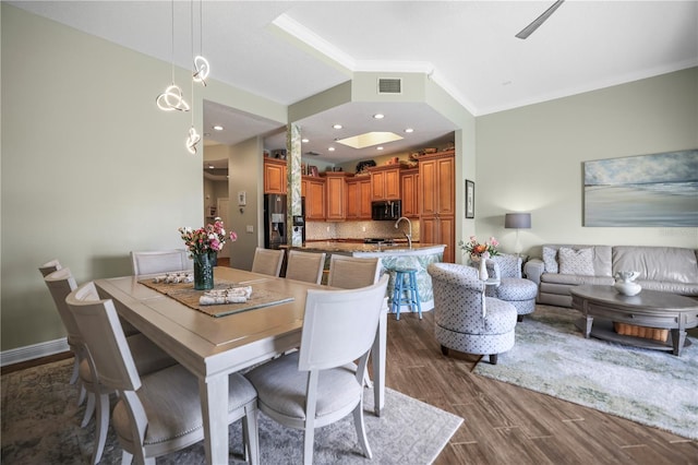 205 Brightwater Dr Unit 101, Clearwater Beach, FL 33767 - dining space featuring ornamental molding, dark wood-type flooring, and baseboards