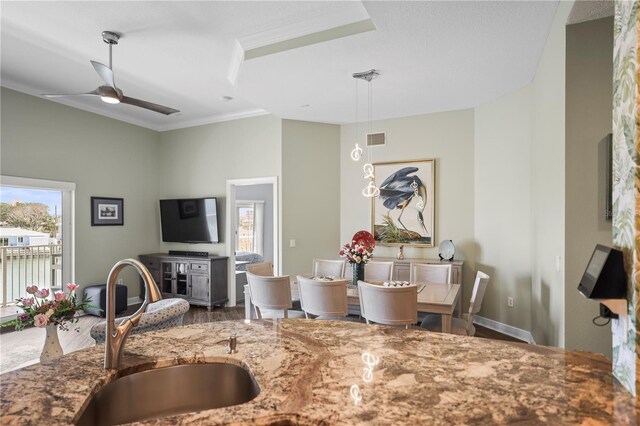 205 Brightwater Dr Unit 101, Clearwater Beach, FL 33767 - kitchen with a sink, stone counters, healthy amount of natural light, wood finished floors, and crown molding