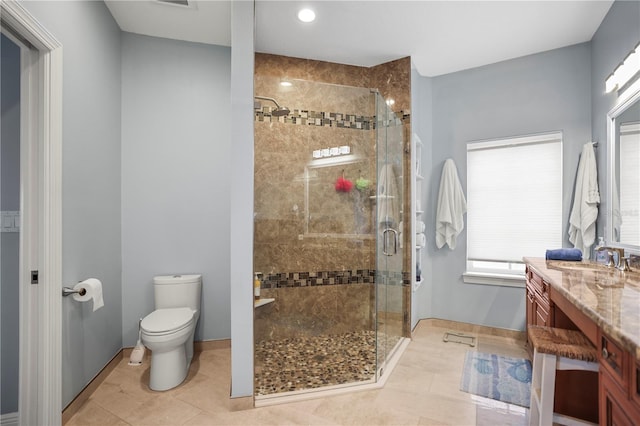 205 Brightwater Dr Unit 101, Clearwater Beach, FL 33767 - bathroom with vanity, toilet, a shower stall, tile patterned flooring, and baseboards