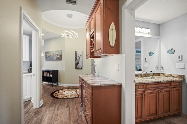 205 Brightwater Dr Unit 101, Clearwater Beach, FL 33767 - full bath with wood finished floors, vanity, and baseboards