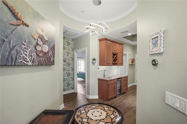205 Brightwater Dr Unit 101, Clearwater Beach, FL 33767 - bar with wine cooler, a sink, dark wood-type flooring, baseboards, and ornamental molding