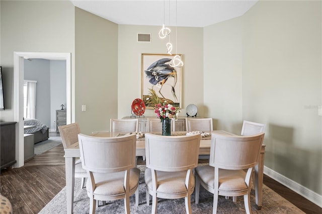 205 Brightwater Dr Unit 101, Clearwater Beach, FL 33767 - dining area featuring wood finished floors and baseboards