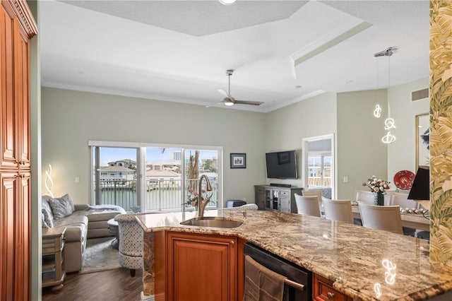 205 Brightwater Dr Unit 101, Clearwater Beach, FL 33767 - kitchen featuring open floor plan, a sink, dark wood-style floors, dishwashing machine, and light stone countertops