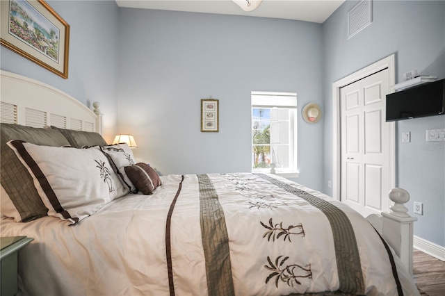 205 Brightwater Dr Unit 101, Clearwater Beach, FL 33767 - bedroom featuring wood finished floors, baseboards, and a closet