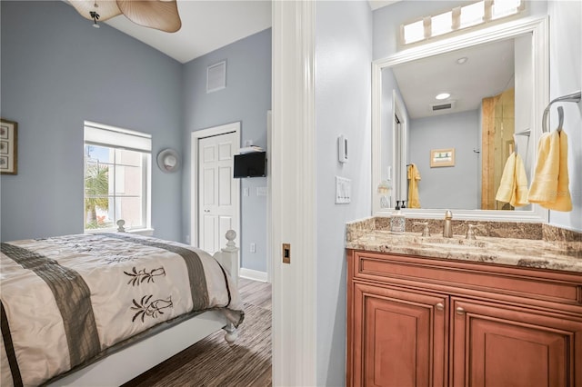 205 Brightwater Dr Unit 101, Clearwater Beach, FL 33767 - bedroom featuring a sink, vaulted ceiling, and baseboards