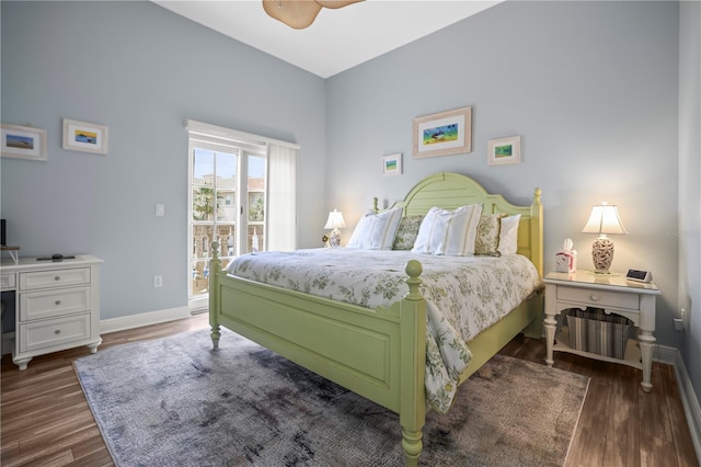 205 Brightwater Dr Unit 101, Clearwater Beach, FL 33767 - bedroom featuring access to exterior, baseboards, and dark wood finished floors