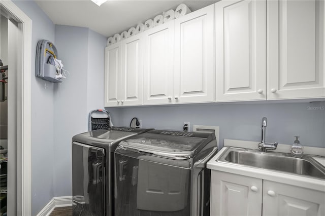 205 Brightwater Dr Unit 101, Clearwater Beach, FL 33767 - laundry area featuring cabinet space, independent washer and dryer, wood finished floors, and baseboards