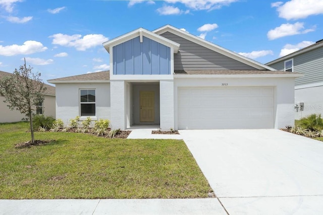 view of front facade with board and batten siding, a front lawn, a garage, driveway, and stucco siding