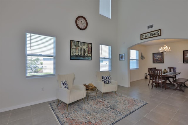 11924 Brighton Knoll Loop, Riverview, FL 33579 - sitting room featuring a chandelier, light tile patterned floors, baseboards, a high ceiling, and arched walkways