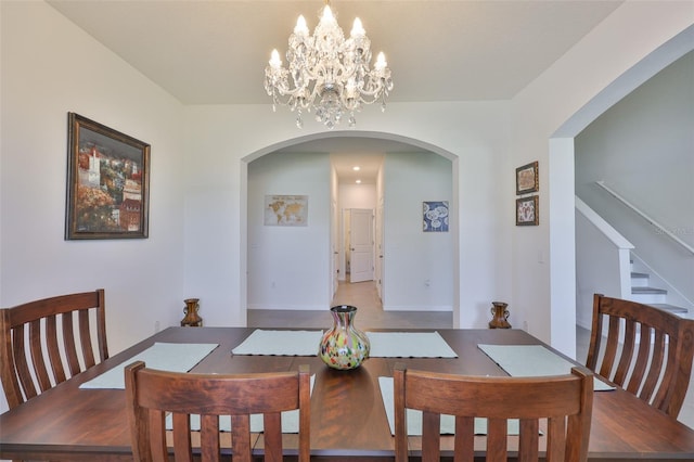 11924 Brighton Knoll Loop, Riverview, FL 33579 - dining area featuring arched walkways, a chandelier, and stairway