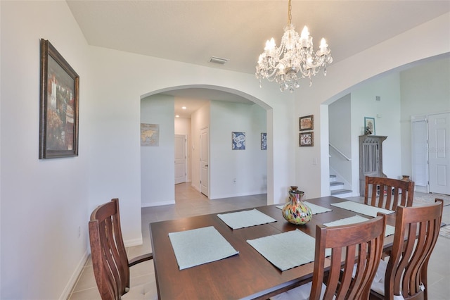 11924 Brighton Knoll Loop, Riverview, FL 33579 - dining area featuring arched walkways, a chandelier, stairs, baseboards, and light tile patterned floors