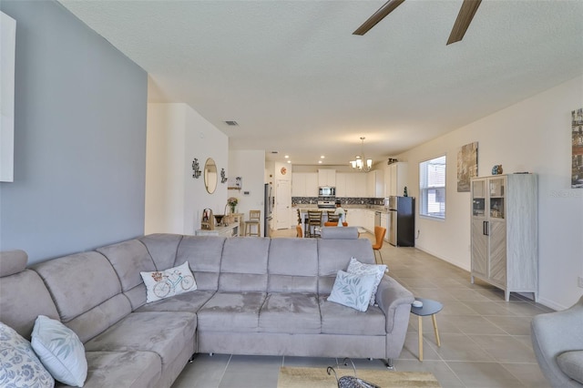 11924 Brighton Knoll Loop, Riverview, FL 33579 - living area featuring a chandelier, light tile patterned floors, ceiling fan, and baseboards