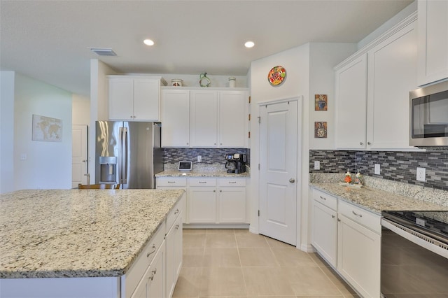 11924 Brighton Knoll Loop, Riverview, FL 33579 - kitchen featuring stainless steel appliances, white cabinets, tasteful backsplash, light stone counters, and recessed lighting