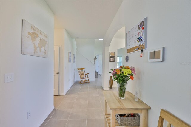 11924 Brighton Knoll Loop, Riverview, FL 33579 - corridor with arched walkways, light tile patterned floors, and baseboards