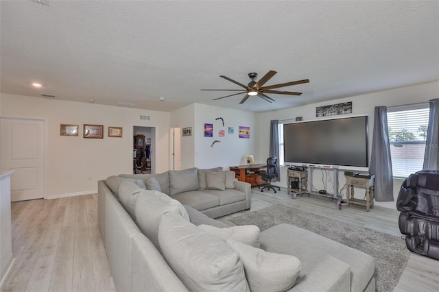 11924 Brighton Knoll Loop, Riverview, FL 33579 - living area with plenty of natural light, ceiling fan, light wood-type flooring, a textured ceiling, and baseboards