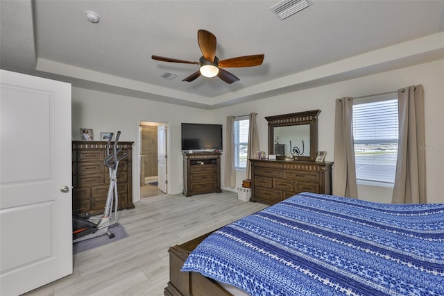 11924 Brighton Knoll Loop, Riverview, FL 33579 - bedroom with a tray ceiling, light wood finished floors, connected bathroom, ceiling fan, and baseboards