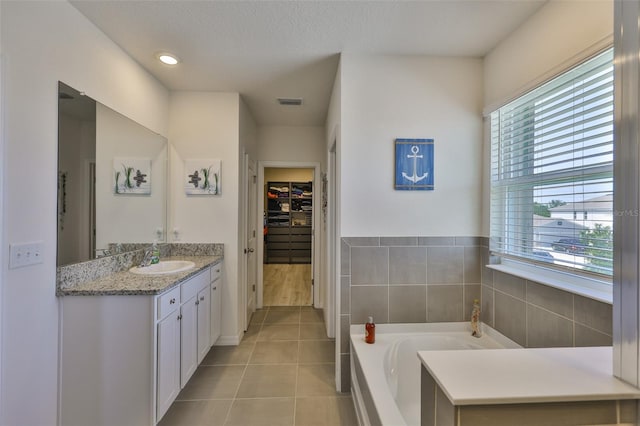 11924 Brighton Knoll Loop, Riverview, FL 33579 - full bath featuring healthy amount of natural light, tile patterned flooring, vanity, and a bath