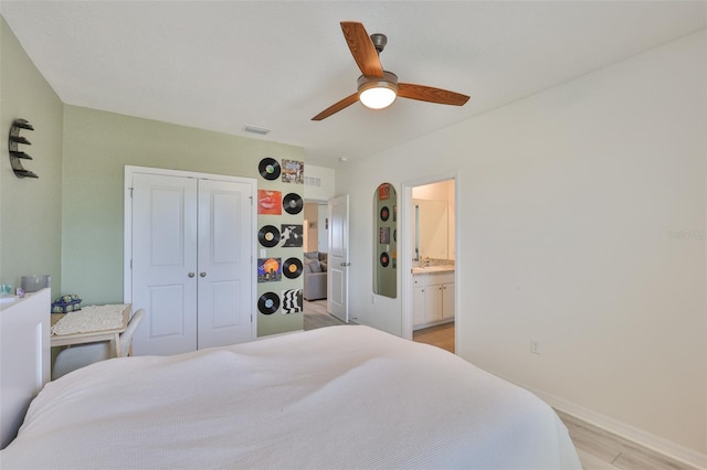 11924 Brighton Knoll Loop, Riverview, FL 33579 - bedroom featuring light wood-style floors, a closet, baseboards, a ceiling fan, and a sink
