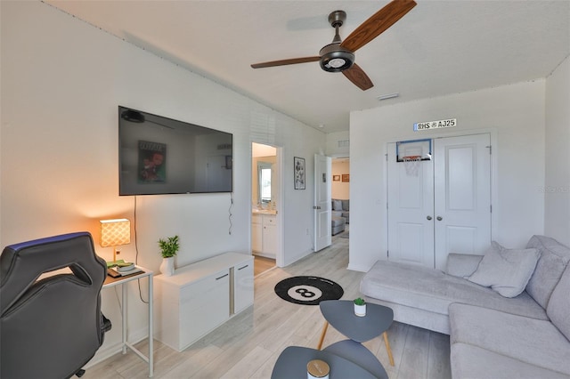 11924 Brighton Knoll Loop, Riverview, FL 33579 - living area with a ceiling fan, light wood-style floors, and baseboards