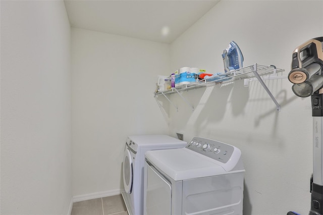 11924 Brighton Knoll Loop, Riverview, FL 33579 - laundry area featuring washer and clothes dryer, light tile patterned flooring, and baseboards
