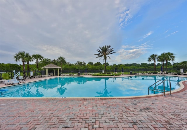 11924 Brighton Knoll Loop, Riverview, FL 33579 - community pool with a gazebo, fence, a patio, and view of scattered trees