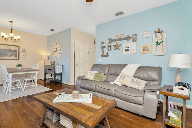living room featuring a chandelier, wood finished floors, and baseboards