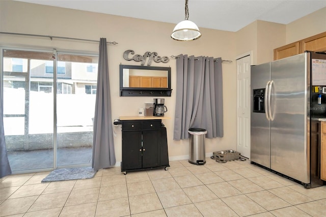 kitchen featuring stainless steel refrigerator with ice dispenser and light tile patterned floors