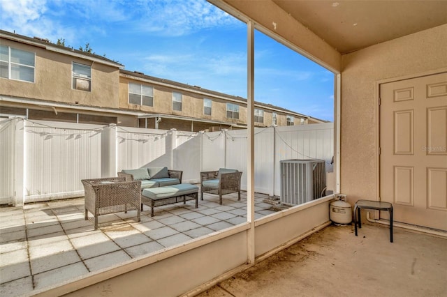 view of patio with central AC, fence, and outdoor lounge area