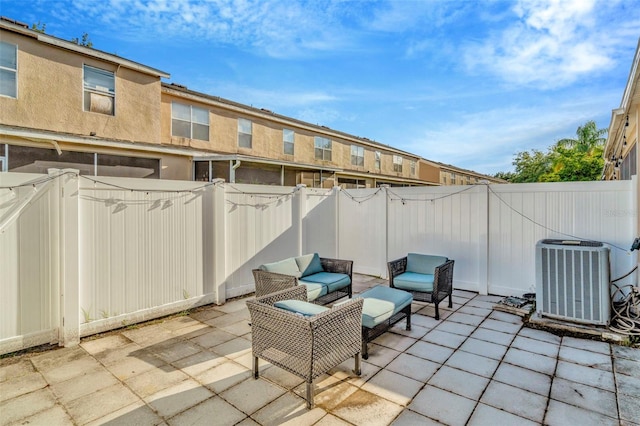 view of patio featuring central AC unit and a fenced backyard