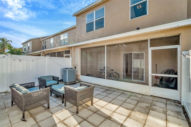 view of patio / terrace with central AC unit, fence, and an outdoor living space