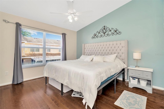 bedroom featuring wood finished floors, lofted ceiling, baseboards, and ceiling fan