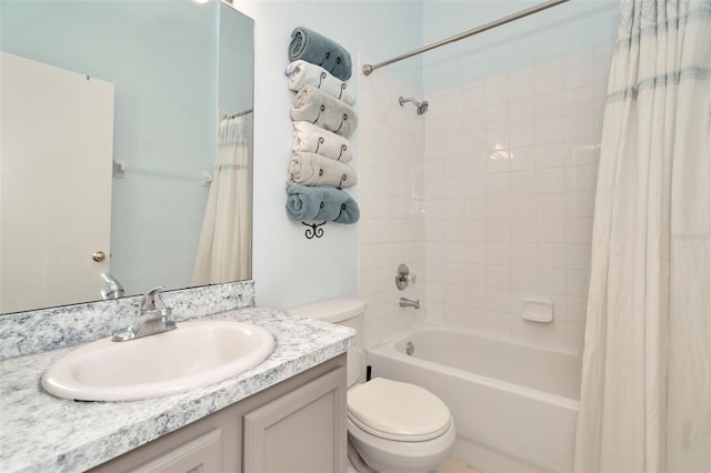 full bathroom featuring toilet, shower / tub combo with curtain, and vanity