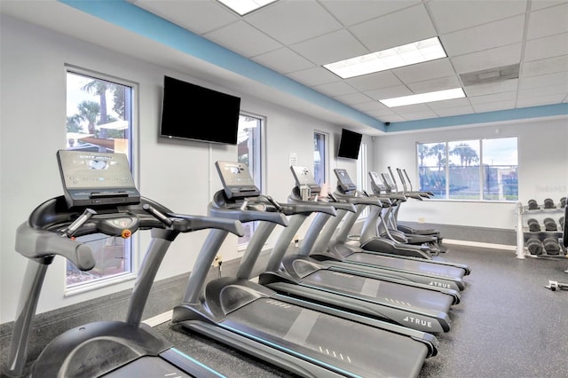 exercise room featuring a drop ceiling and healthy amount of natural light