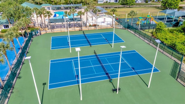 view of tennis court featuring fence