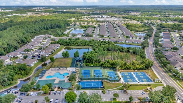 aerial view of property's location with a large body of water, a heavily wooded area, and nearby suburban area
