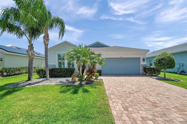 764 W Bayshore Dr, Tarpon Springs, FL 34689 - ranch-style home featuring decorative driveway, an attached garage, a front lawn, and stucco siding