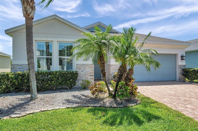 764 W Bayshore Dr, Tarpon Springs, FL 34689 - view of front of property with driveway, stone siding, a garage, and stucco siding