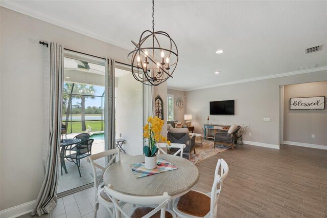 764 W Bayshore Dr, Tarpon Springs, FL 34689 - dining area with ornamental molding, baseboards, light wood-style flooring, a chandelier, and recessed lighting