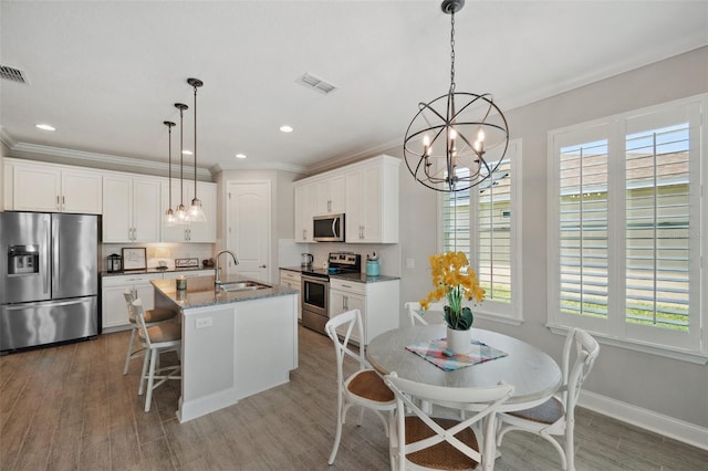 764 W Bayshore Dr, Tarpon Springs, FL 34689 - kitchen with stainless steel appliances, a chandelier, a sink, tasteful backsplash, and ornamental molding