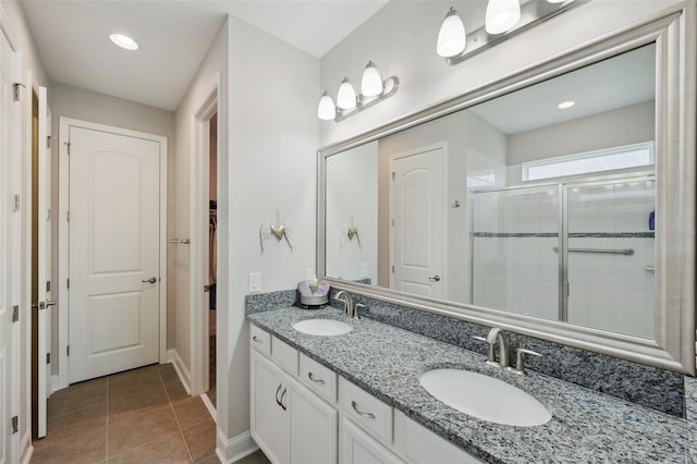 764 W Bayshore Dr, Tarpon Springs, FL 34689 - full bathroom featuring a stall shower, tile patterned floors, baseboards, double vanity, and recessed lighting