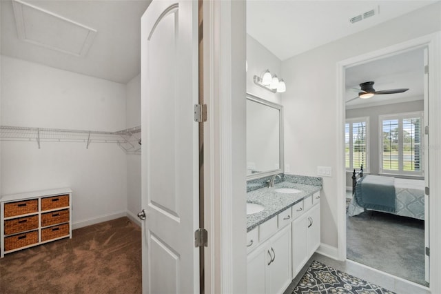 764 W Bayshore Dr, Tarpon Springs, FL 34689 - ensuite bathroom with a walk in closet, baseboards, double vanity, and ceiling fan