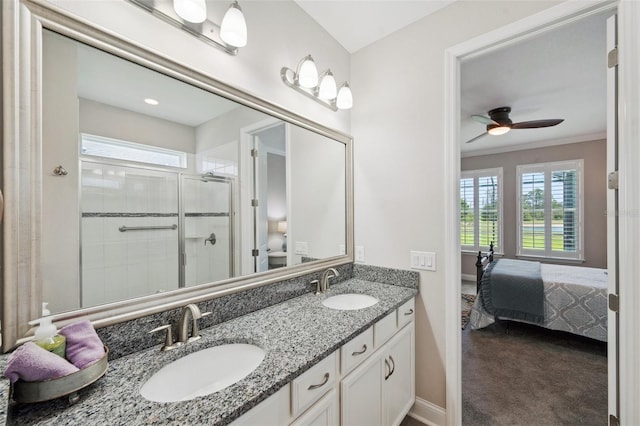 764 W Bayshore Dr, Tarpon Springs, FL 34689 - ensuite bathroom with a stall shower, double vanity, ceiling fan, baseboards, and crown molding