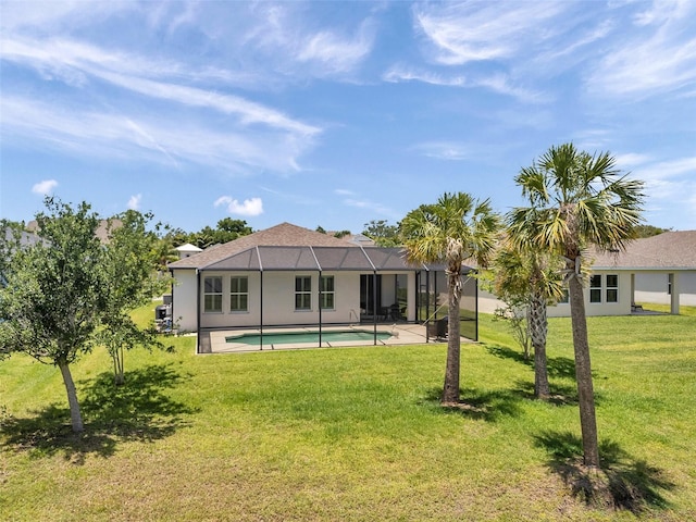 764 W Bayshore Dr, Tarpon Springs, FL 34689 - rear view of house featuring a lawn, an outdoor pool, a patio, glass enclosure, and stucco siding