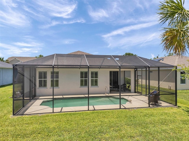 764 W Bayshore Dr, Tarpon Springs, FL 34689 - rear view of house with a patio, a lawn, stucco siding, and an outdoor pool