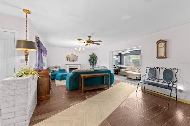 6801 Pinellas Point Dr S, Saint Petersburg, FL 33712 - living area with a fireplace, wood finished floors, a ceiling fan, and a chandelier